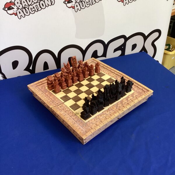Intricately hand-carved wooden chess set with detailed chessmen.