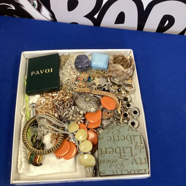 Colourful tray of vintage costume jewellery and fashion accessories.
