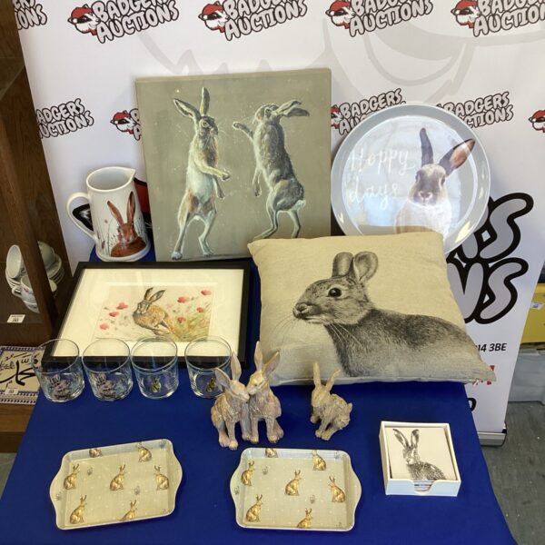 Hare collectible lot featuring figurines and glassware on display.
