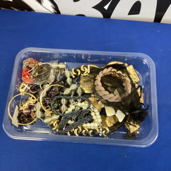 Tray of vintage costume jewellery with necklaces and brooches.