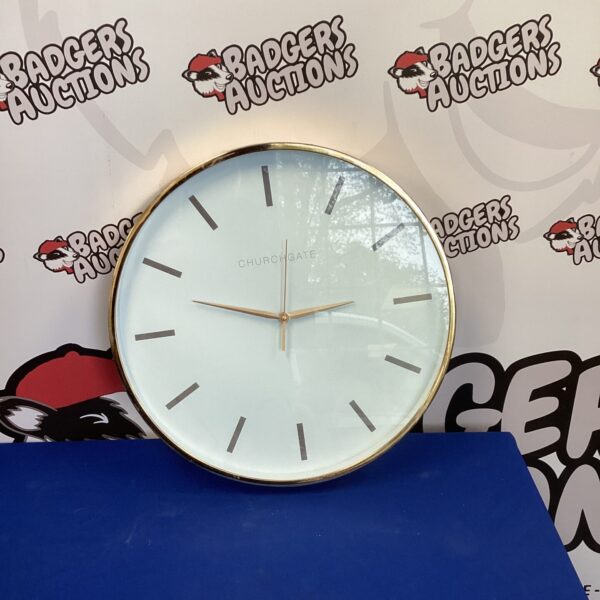 Large white Churchgate wall clock with black hands.