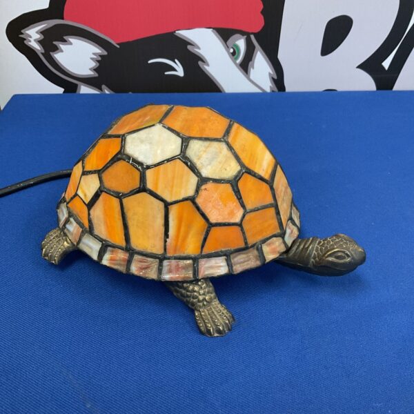 Vibrant stained glass tortoise table lamp in a Tiffany style.