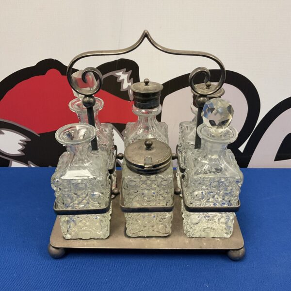 Antique silver plate and cut glass cruet set for table condiments.