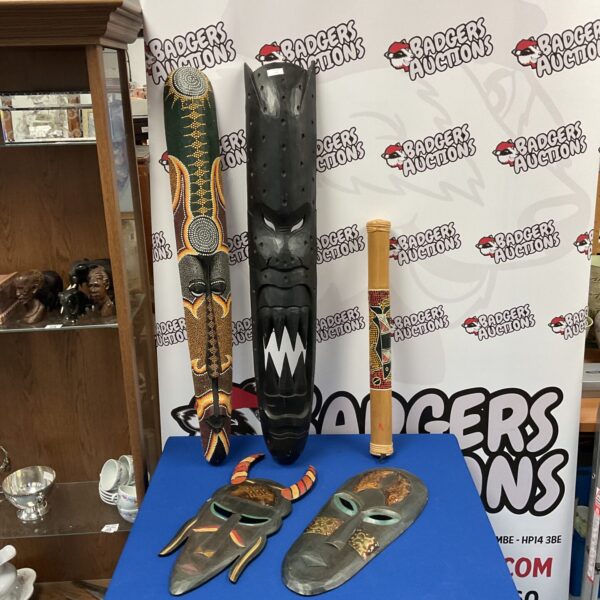 Lot of four large African tribal masks and a rain maker.