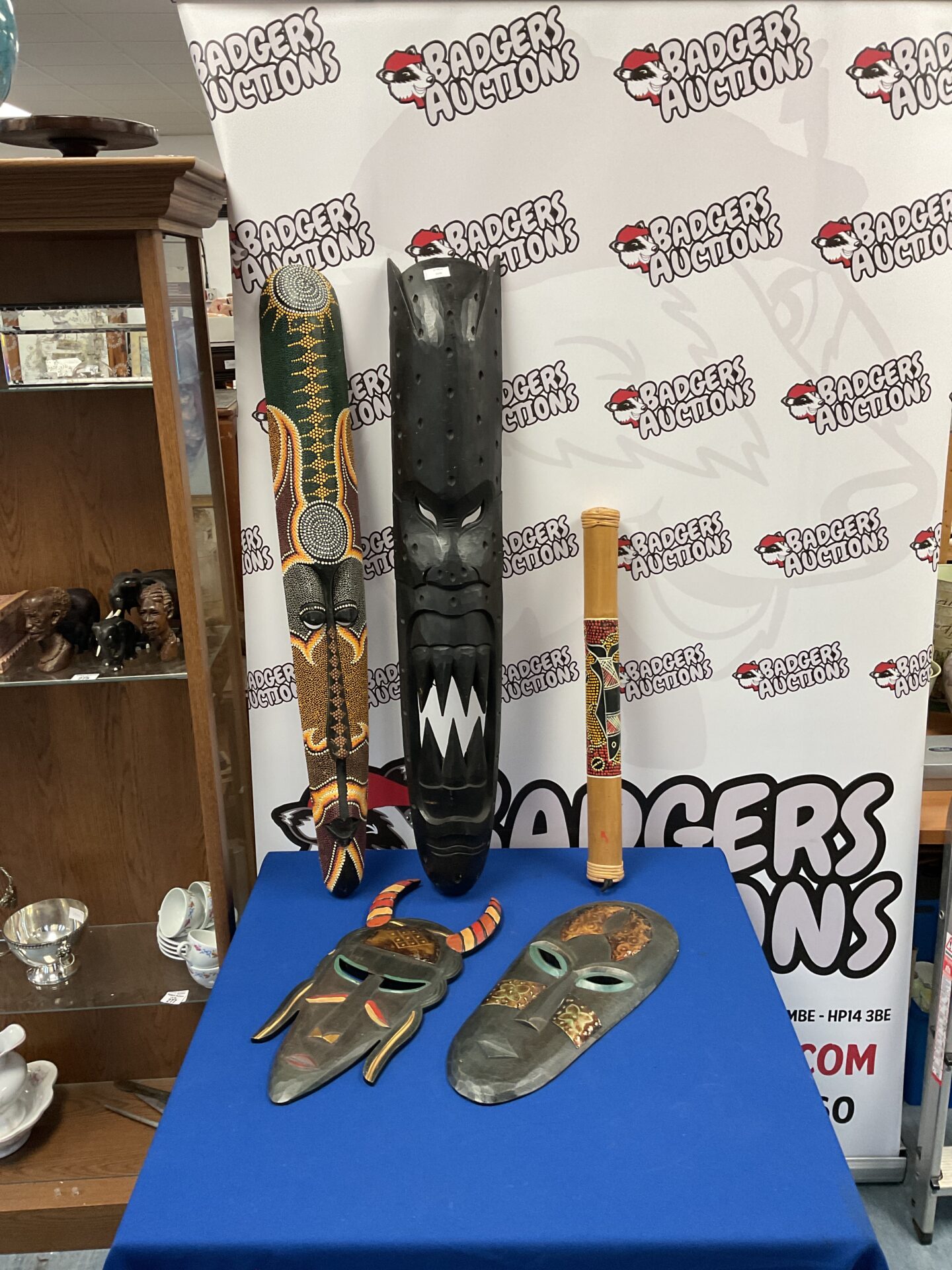 028 Four large tribal African carved wooden masks & a rain maker
