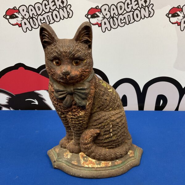 Antique cast iron cat doorstop, vintage home decor item.