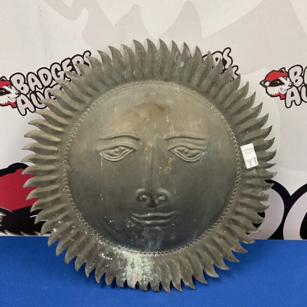Vintage brass sun wall art with a central face.