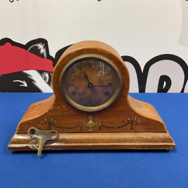 Antique brass mantle clock with white enamel dial.