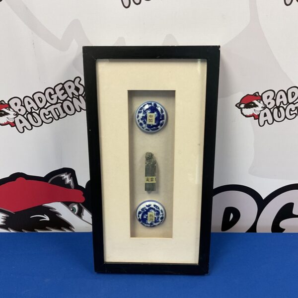 Framed antique Chinese dragon pot lids and wax seal display.