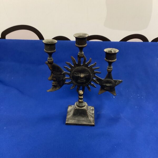 Dark metal sun moon star candlestick for altar or home decor.