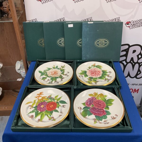 Set of four Portmeirion Susan Williams Ellis rose plates on display.