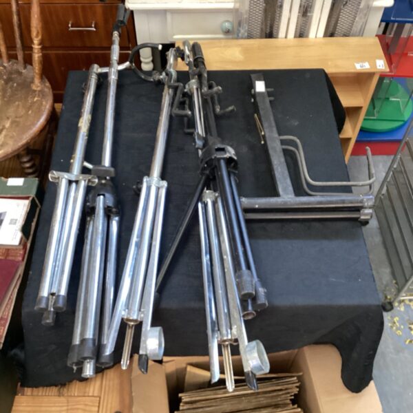 Lot of five microphone stands and one guitar stand for musicians.