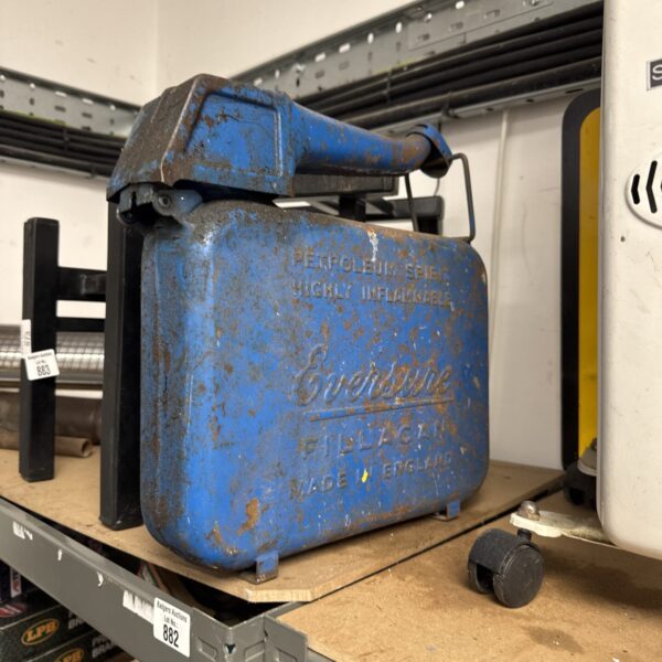 Vintage blue Eversure fuel can, a collectible garage item.