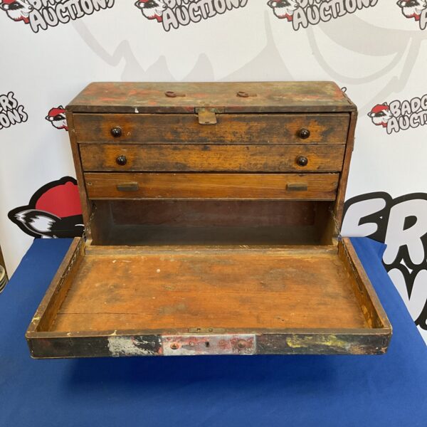 Vintage carpenter's tool chest with drawers, antique wooden toolbox.