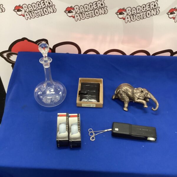 Mixed lot of vintage collectibles including glass decanter and metal elephant.