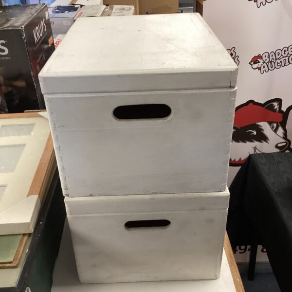 White painted wooden storage boxes with handles for home organisation.