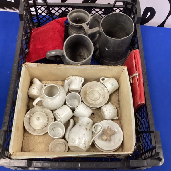 Vintage miniature tea set and ceramic lot on display.