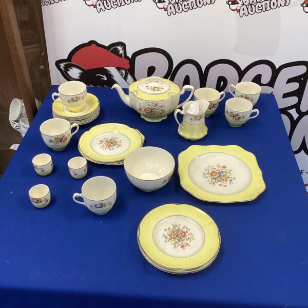 Vintage Johnson Bros china tea set with floral pattern on display.
