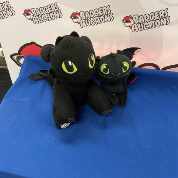 Two Dreamworks How to Train Your Dragon Toothless plushies.