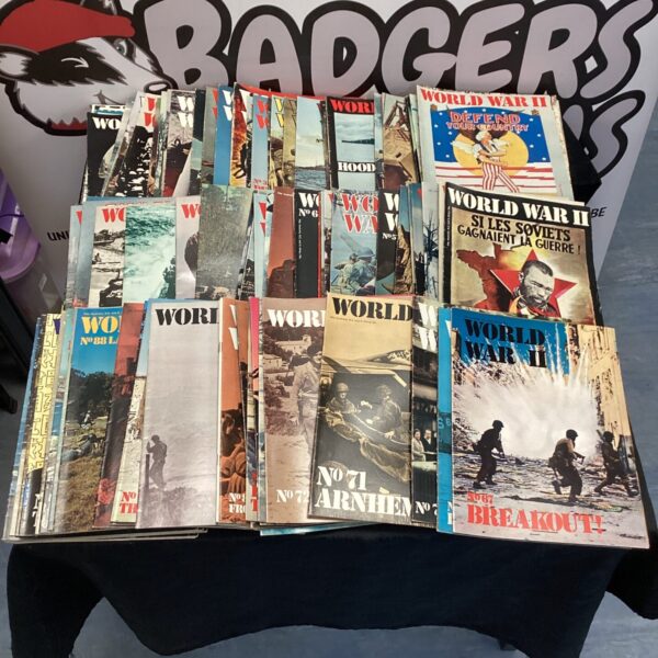 Stack of vintage World War II magazines, historical wartime publications.