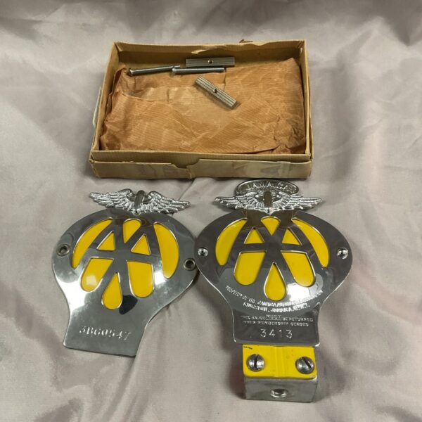 Vintage AA badges including a Jamaica badge, collectible sobriety tokens.