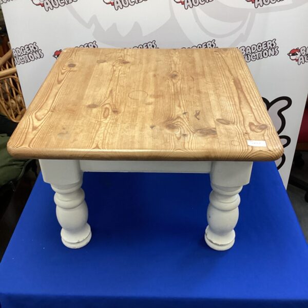 Rustic pine coffee table with turned legs, ideal for farmhouse style.