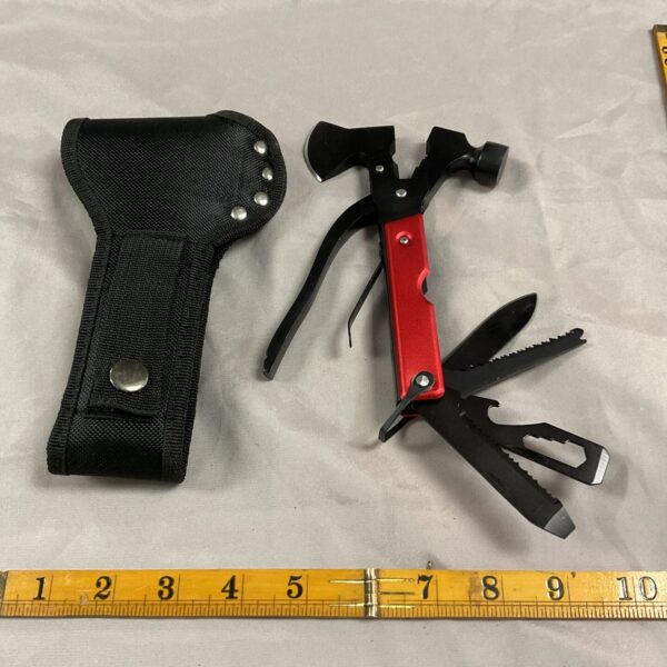 Black nylon sheath holding a silver and red pocket axe multi tool.