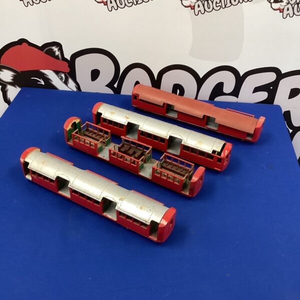Four red London Underground model carriages for collectors.