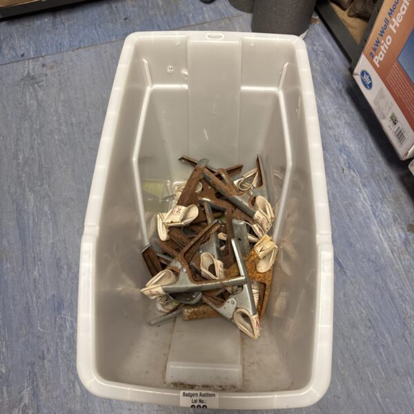 Quantity of used metal market stall canopy clamps for outdoor events.