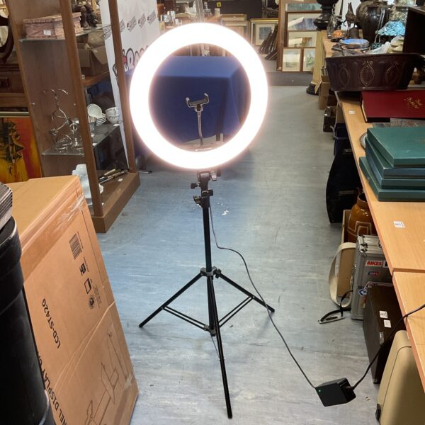 Portable Rio LED ring light on tripod stand for photography.