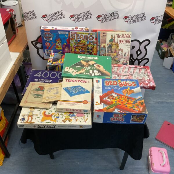 Mixed lot of vintage board games, books, and comics for collectors.