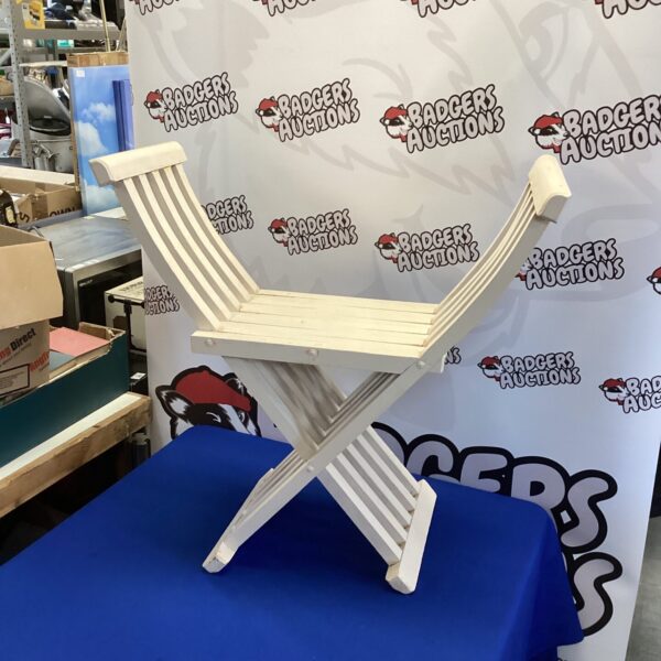 Vintage wooden scissors chair for patio or garden use.
