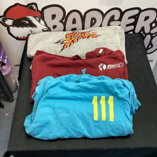 XL hoodie lot featuring Street Fighter, Marvel, and Fallout designs.