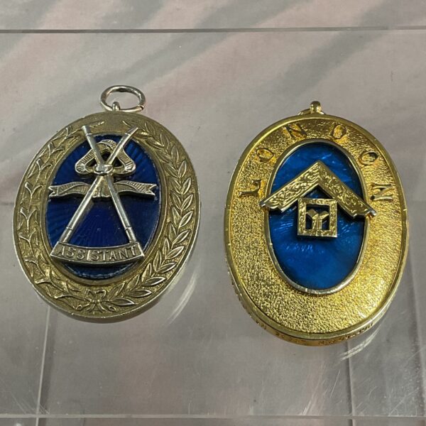 Antique masonic collar jewel with "ASSISTANT" banner and crossed swords.