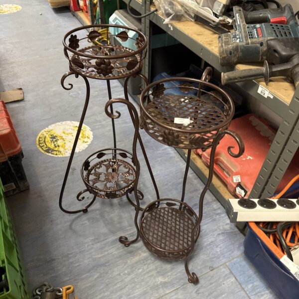 Two tiered metal plant stand with dark finish.