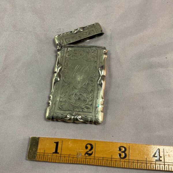 Antique whitemetal card case with embossed floral design.