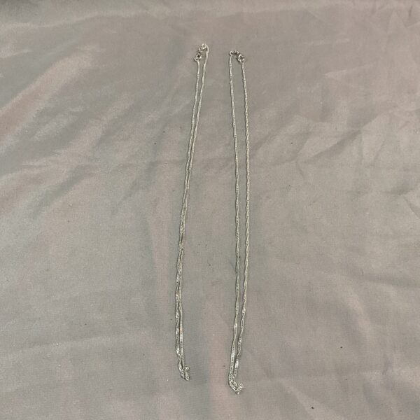 Two delicate 925 silver necklaces with small pendants.