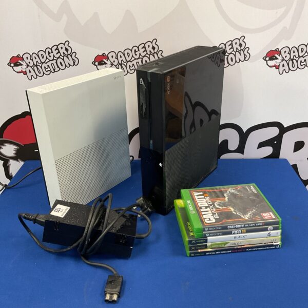 Two Microsoft Xbox One consoles with power cables displayed.