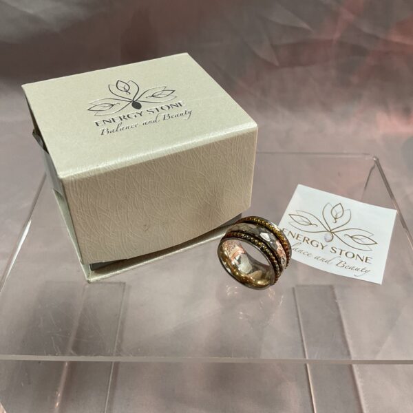 Silver spinner ring with energy stone and rotating bands.
