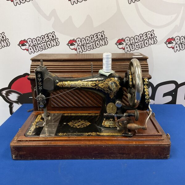 Antique Singer sewing machine model 847930 with ornate detailing.