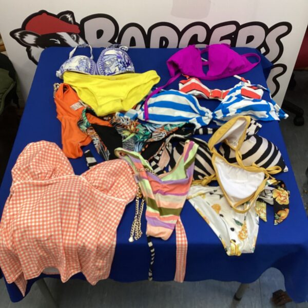 Mixed lot of colourful ladies' swimwear, including bikini tops and bottoms.