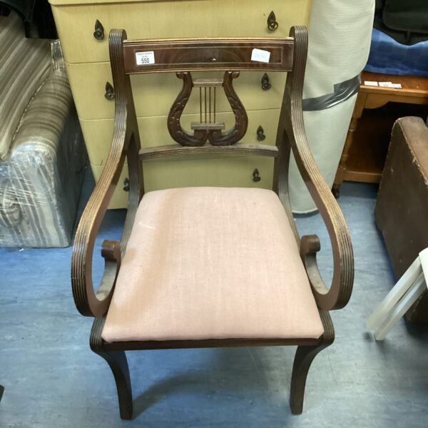 Vintage mahogany harp back chair with warm wood tones.