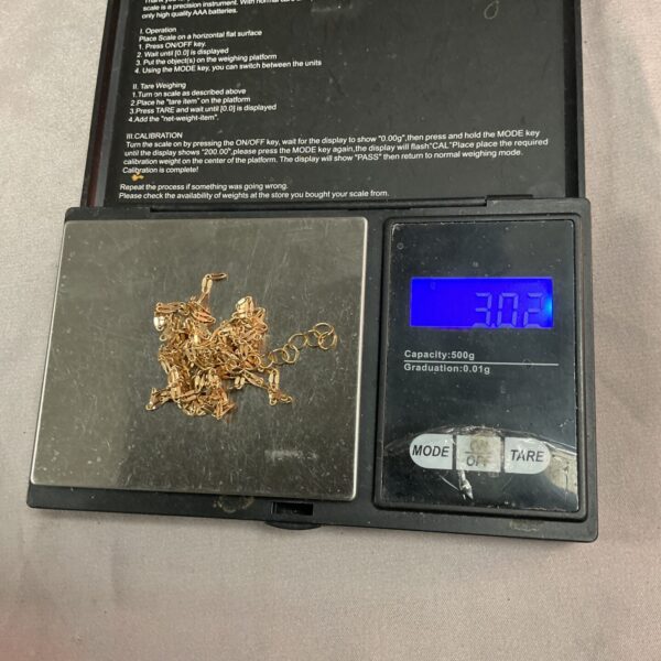 Digital pocket scale displaying 3.02g for weighing small items.