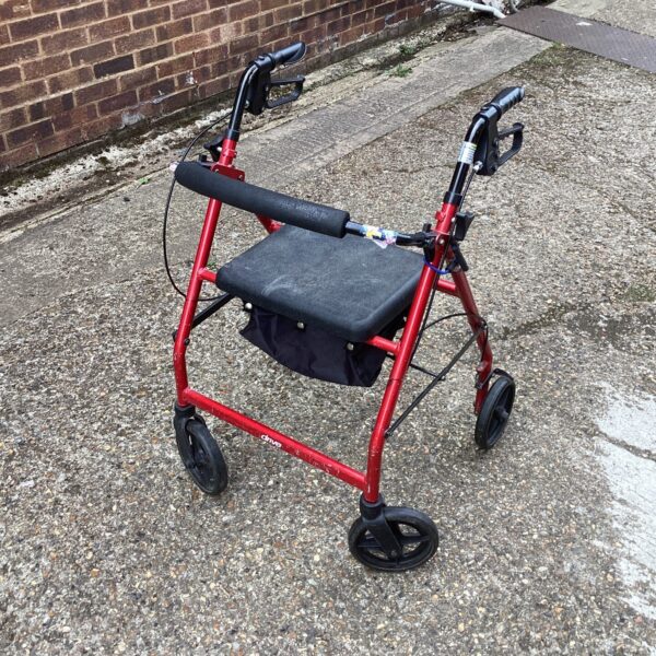 Red walking aid trolley with seat and basket for mobility assistance.