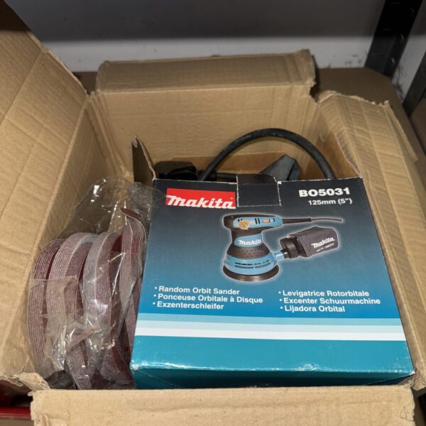 Used Makita BO5031 orbital sander for wood finishing.