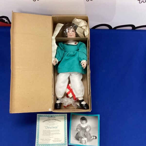 Ashton Drake Christmas doll with certificate of authenticity.