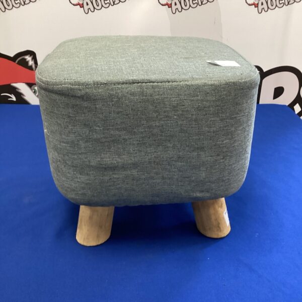 Grey vintage footstool with wooden legs for home decor.