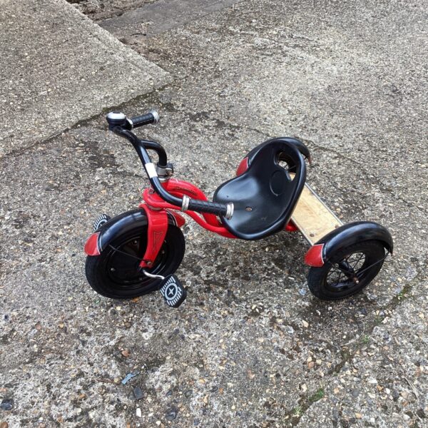 Vintage red Schwinn tricycle, a classic children's ride-on toy.