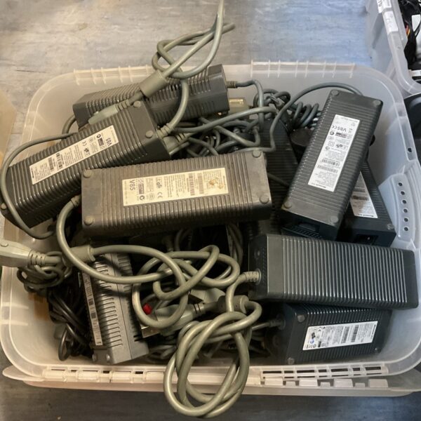 Large lot of Microsoft Xbox 360 power supplies for gaming consoles.