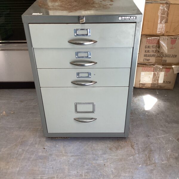 Vintage Bisley steel cabinet with multiple drawers, showing signs of wear.